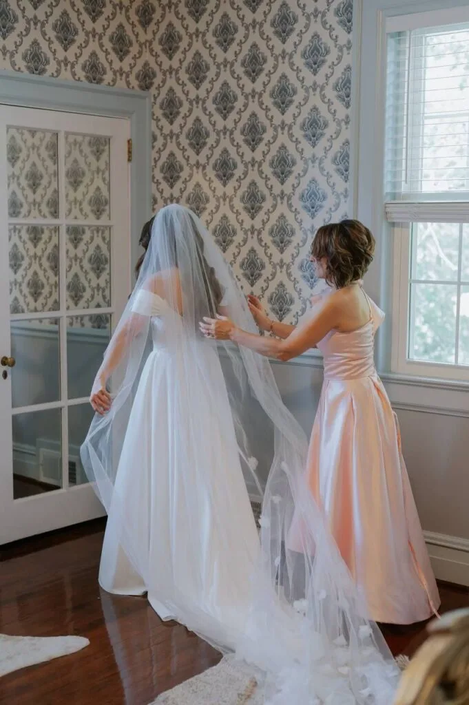 Bride getting ready with bridesmaid at WestWind Estate